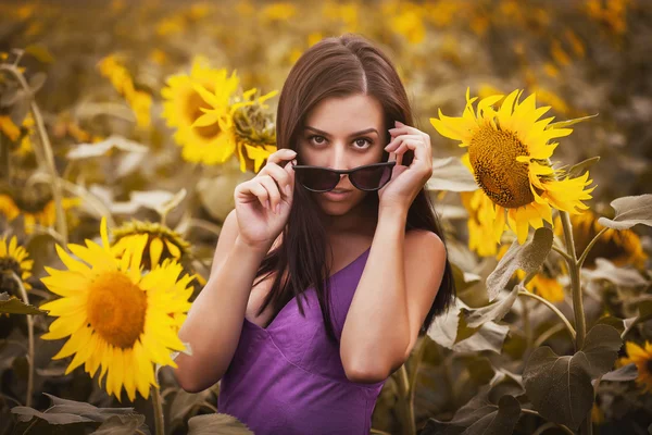 Sexy meisje in een zonnebloem veld — Stockfoto