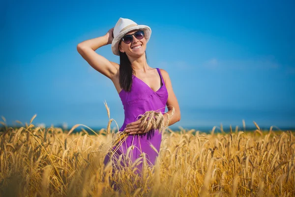 Happy girl is walking on the yellow field — Stock Photo, Image