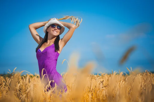 Pretty woman on the yellow field — Stock Photo, Image