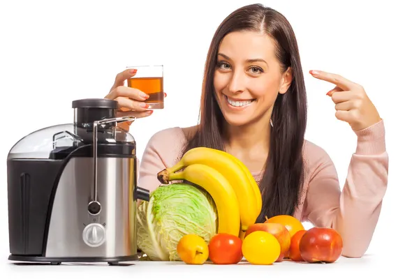Happy woman is pressing the juice from the fruit — Stock Photo, Image