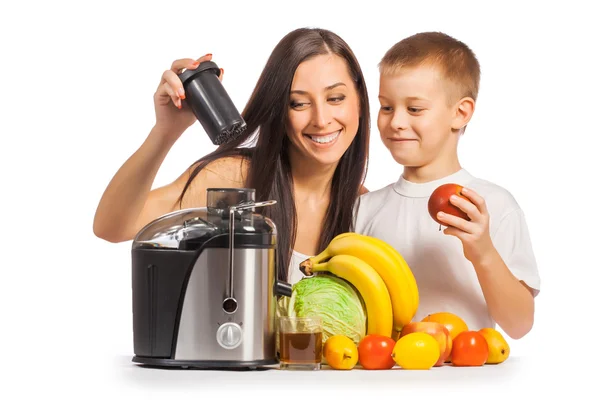 Happy family are pressing the juice from the fruit — Stock Photo, Image