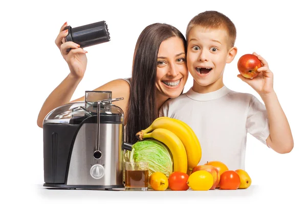 Happy family are pressing the juice from the fruit — Stock Photo, Image