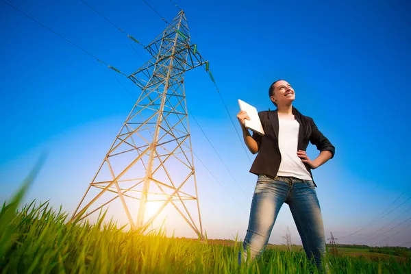 Pretty businesswoman in a field with a laptop — Stock Photo, Image