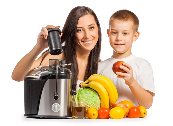 Happy family are pressing the juice from the fruit — Stock Photo, Image