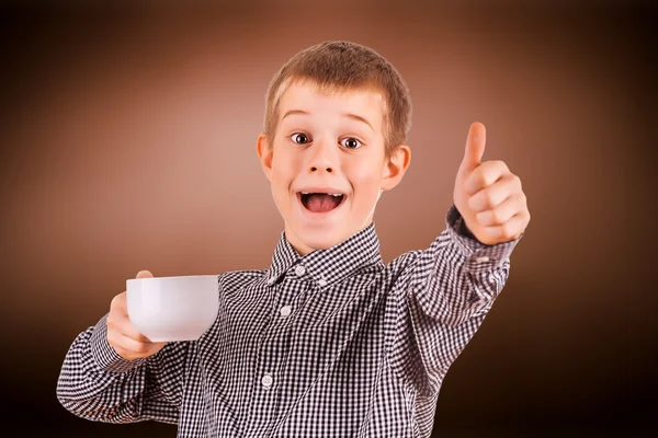 Cute boy with white cup of tea — Stock Photo, Image