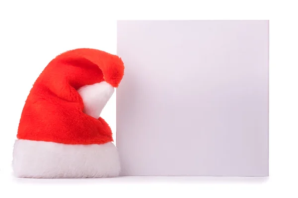 Caja blanca con un sombrero rojo de Santa Claus. aislado — Foto de Stock