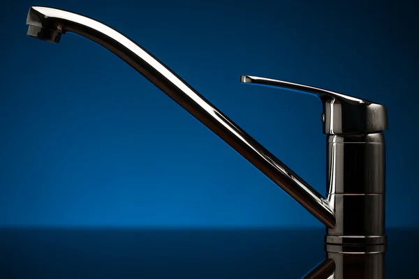 Beautiful chrome faucet on the blue — Stock Photo, Image
