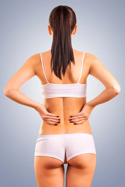 Sexy athletic girl isolated on blue background — Stock Photo, Image