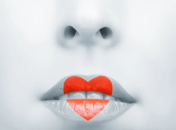 Red heart on lips. love — Stock Photo, Image