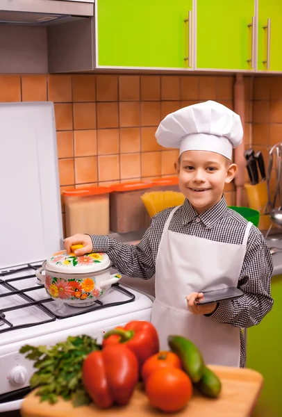 Boy chef is cooking on the kitchen — Stock Photo, Image