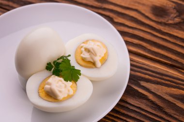Deviled eggs with parsley in a plate clipart