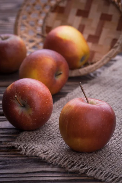 Red apples on wooden table, selective focus — Stock Photo, Image