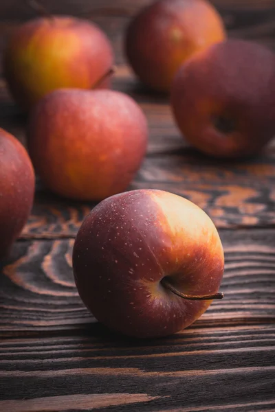 Red apples on wooden table, selective focus — Stock Photo, Image