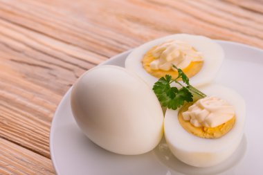 Deviled eggs with parsley in a plate clipart
