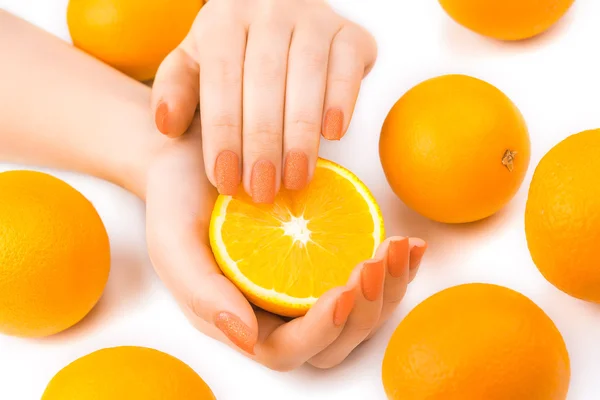 Beautiful orange manicure with oranges. on the white — Stock Photo, Image