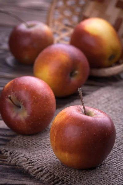 Red apples on wooden table, selective focus — Stock Photo, Image