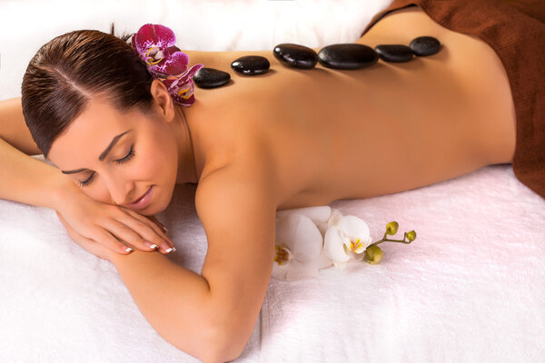 Adult woman in spa salon having body relaxing massage.
