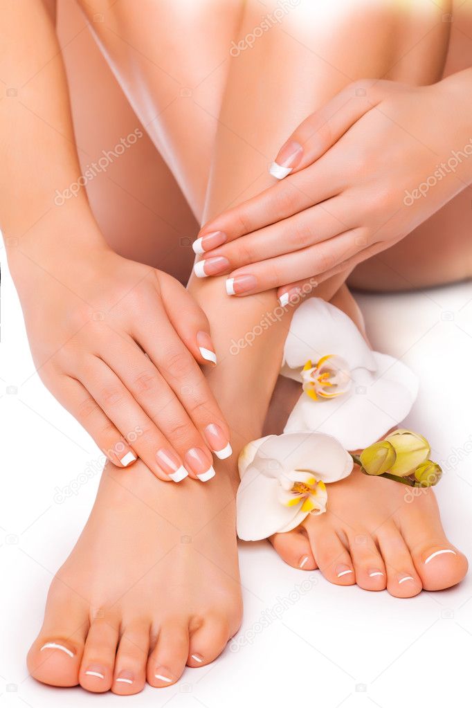 Beautiful french manicure and pedicure  with white orchid on the white