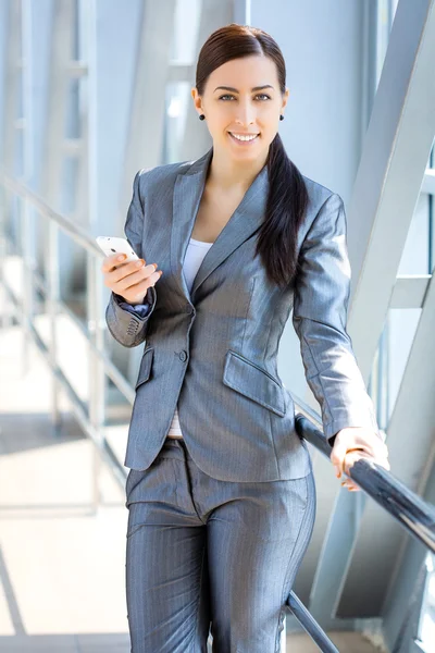 Sexy businesswoman on the blue modern background — Stock Photo, Image