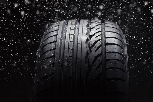Summer Car tires with snow on black background — Stock Photo, Image