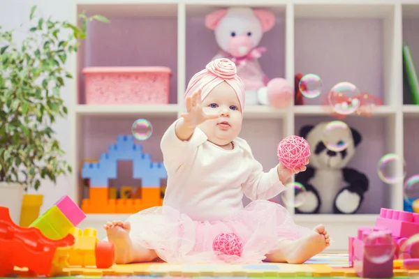 Baby playing with colourful building blocks at home or kindergarten — Stockfoto