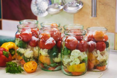 The process of preserving cucumbers and tomatoes for the winter. selective focus