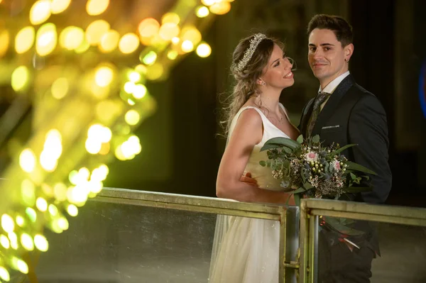 Couple on their wedding apparel with christmas street decoration at night