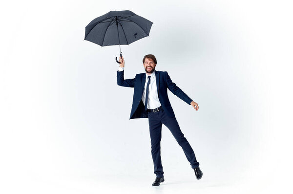 man in suit holding an umbrella in his hands elegant style weather rain