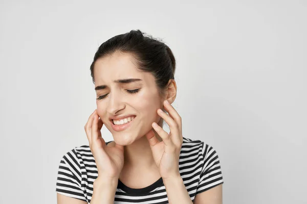 Emocionální žena drží na tvář bolesti zubů zdravotní péče světlo na pozadí — Stock fotografie