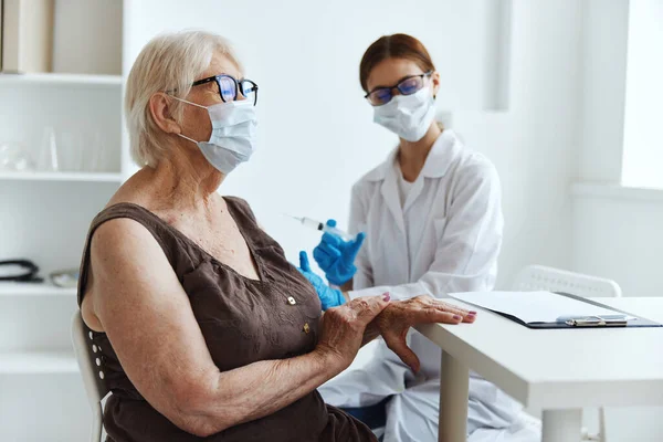 医療用マスクをした高齢女性ワクチンパスポートの健康管理 — ストック写真