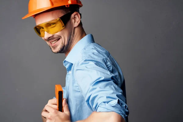 Man wearing yellow glasses with orange paint safety work service — Stock Photo, Image
