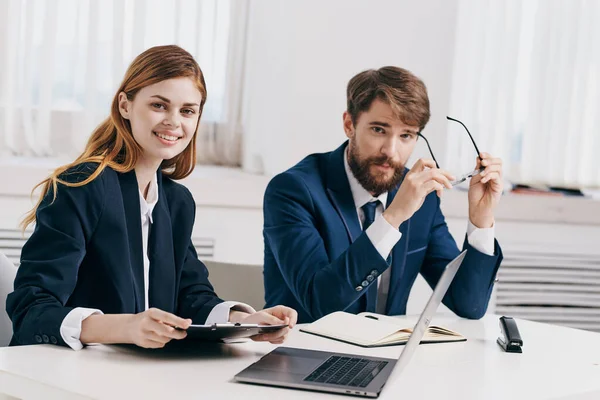 man and woman managers work together in front of laptop office technology