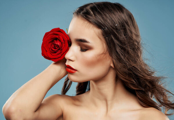 woman bright makeup rose in hand luxury blue background