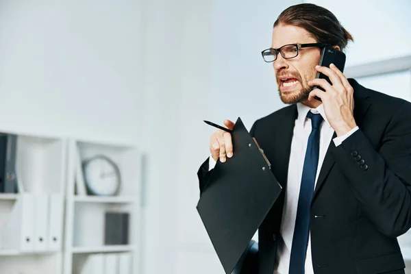 Man in a suit documents in hand communication by phone executive — Stock Photo, Image