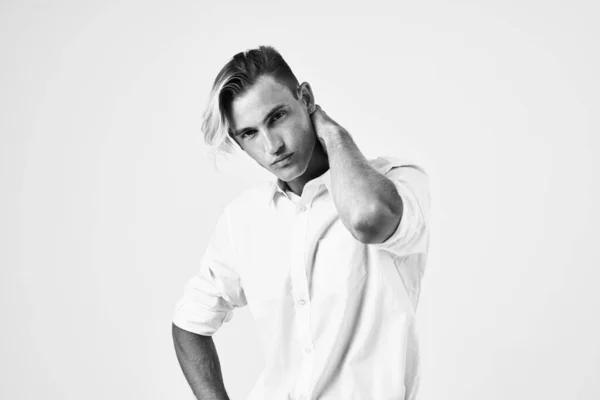 Um homem com um penteado na moda em uma camisa branca modelo olhar atraente — Fotografia de Stock