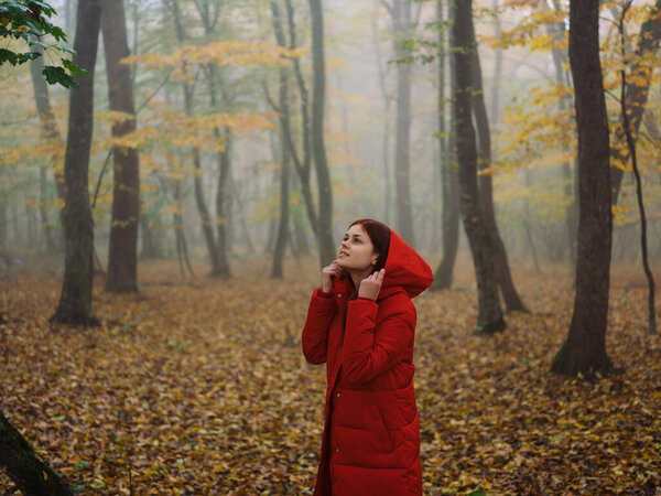 Woman in red jacket autumn forest fresh air nature. High quality photo