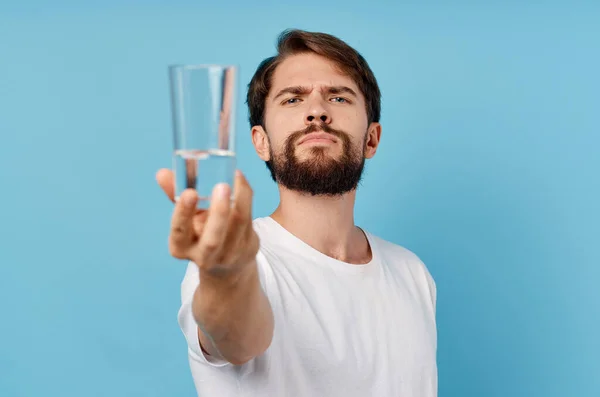 pretty man glass of water blue background