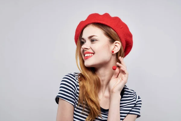Bella donna in una t-shirt a righe rosso labbra gesto con le mani sfondo chiaro — Foto Stock