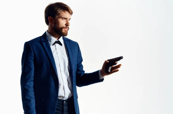 Man Secret agent with a gun in the hand on  isolated background. High quality photo