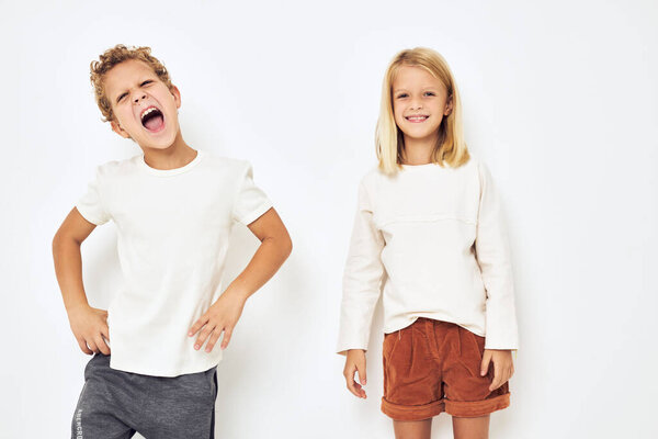 cheerful children dance gesticulate with their hands isolated background