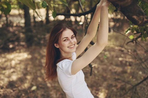 Hezká žena sedí v blízkosti stromu krajiny — Stock fotografie