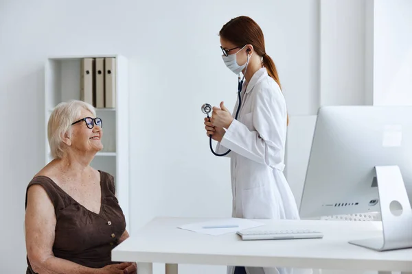 Medico in maschera medica discussione con l'assistenza sanitaria del paziente — Foto Stock