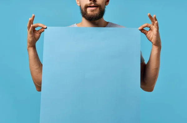 bearded man with blue banner in hands