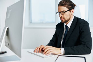 Erkek müdür bilgisayarda çalışıyor.