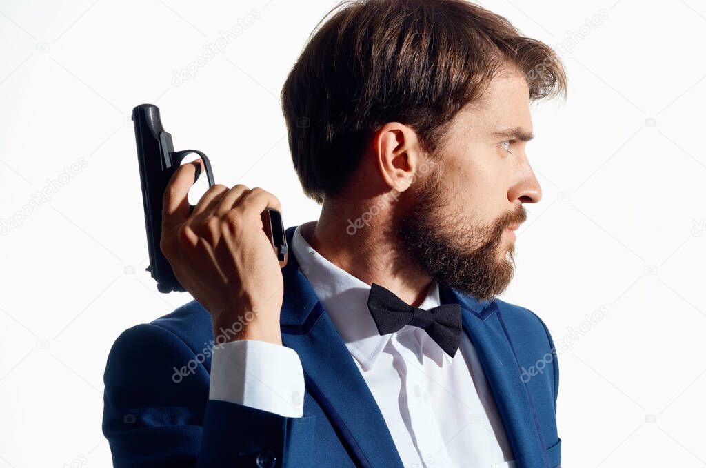 a man in a suit with a gun in his hands Agent secret