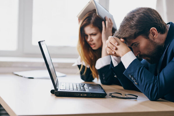 managers in the office in front of a laptop career work professionals