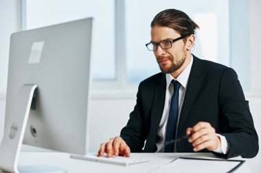 Masaüstü ofis bilgisayar yöneticisinin yanındaki erkek yönetici