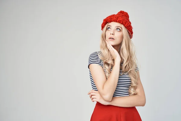Csinos nő csíkos pólóban piros kalap pózol stúdió — Stock Fotó