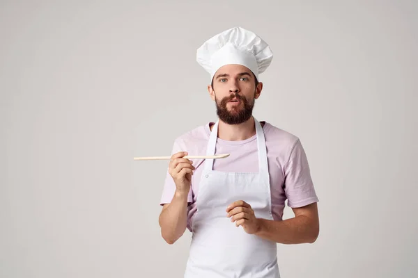 bearded man chef with a white cap on his head