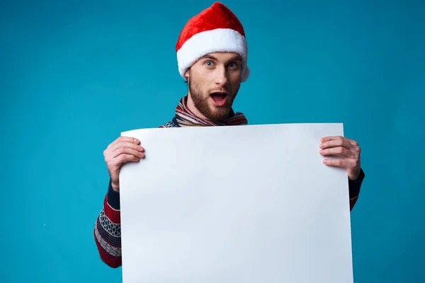 handsome man in a santa hat holding a banner on  isolated background. High quality photo